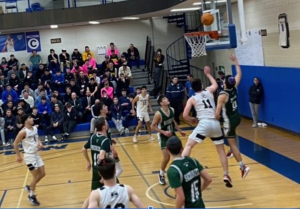 LIVE: Sophomore Sam Jacobson #11 shoots a layup in the fourth quarter against DRS. Click on the link in the story to watch this mornings game.